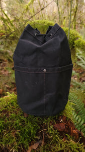 Black Waxed Canvas Cedar Bucket Bag with Outside Pockets.