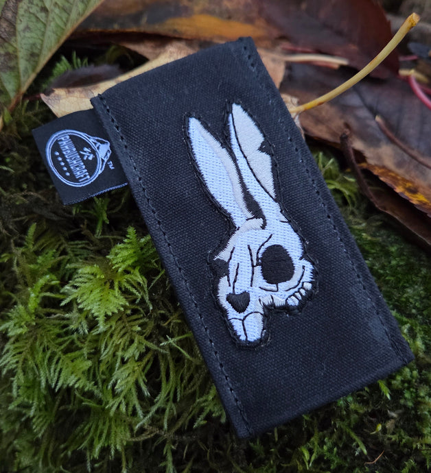 Black patch with a white skull design on a natural background