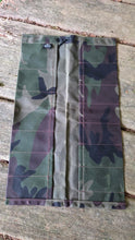 Camouflage-patterned pouch on a wooden surface