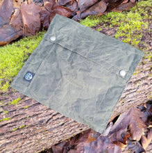 Flat Laying Waxed Canvas bag designed to hold outdoor gear