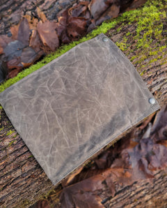 Flat Laying Waxed Canvas bag designed to hold outdoor gear