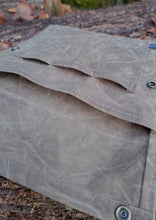 Flat Laying Waxed Canvas bag designed to hold outdoor gear
