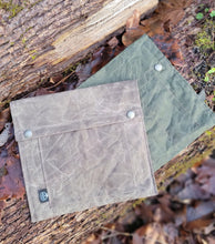 Flat Laying Waxed Canvas bag designed to hold outdoor gear